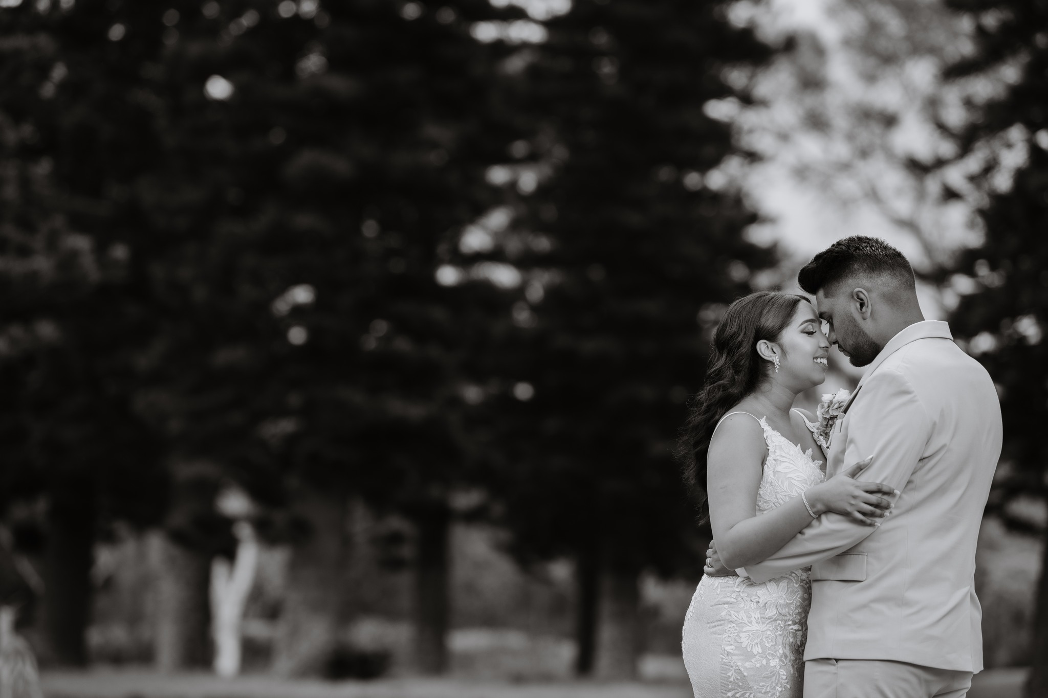  black and white photo of man and wife embracing 