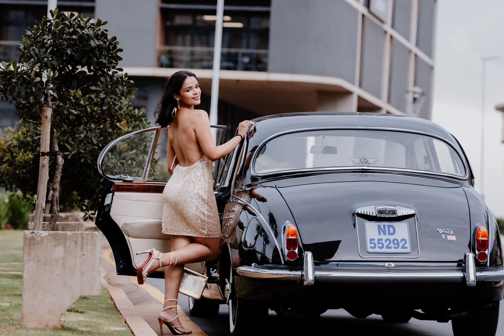  woman posing outside car door 