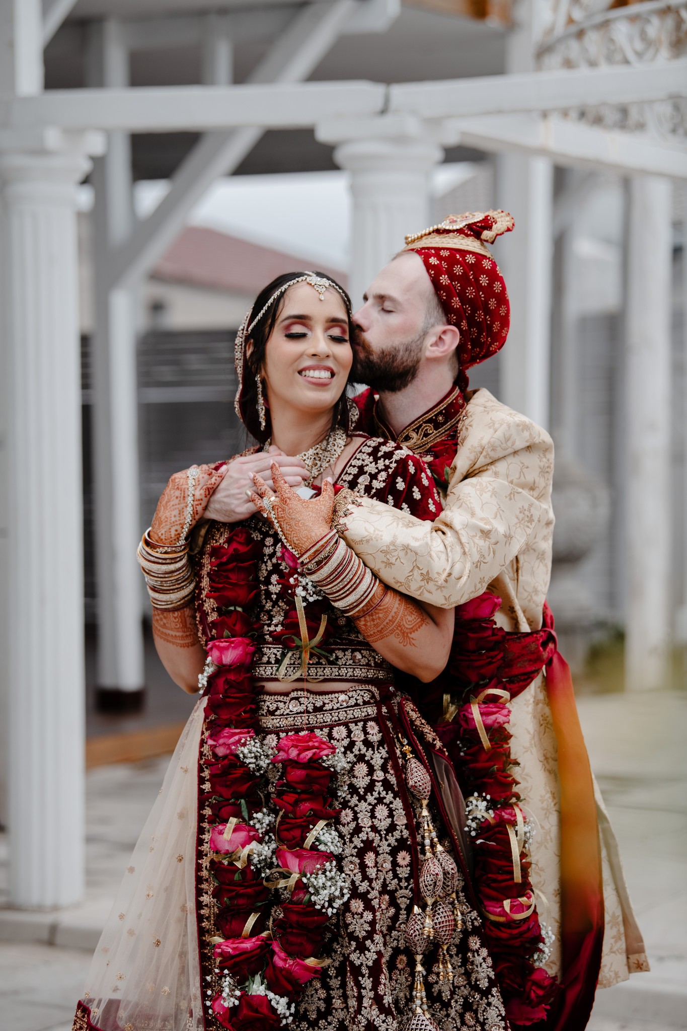  man kissing wife on her head 