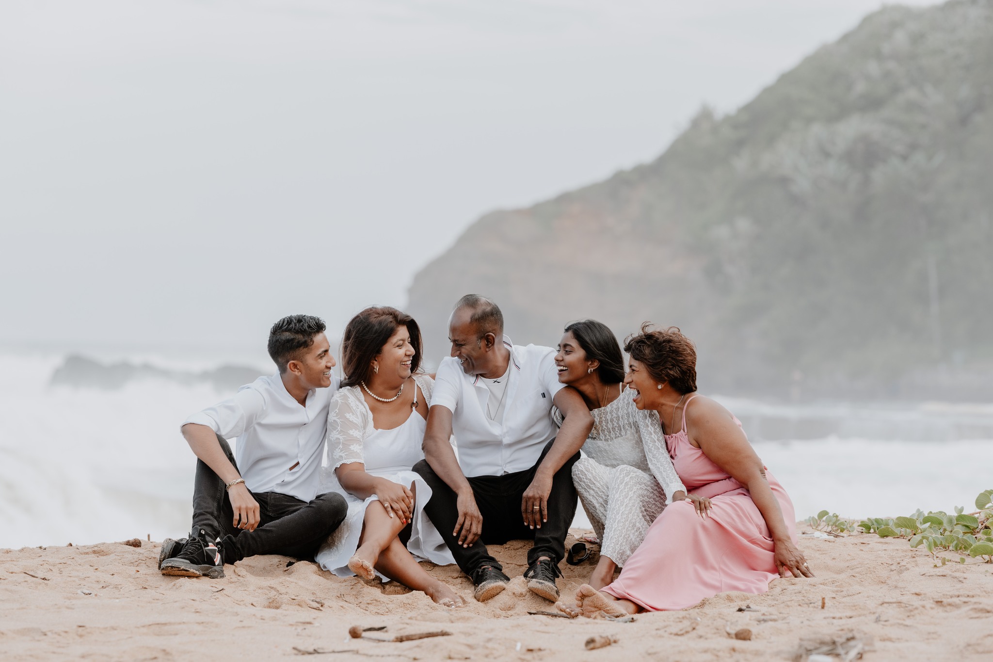  family of five sitting on the beach 