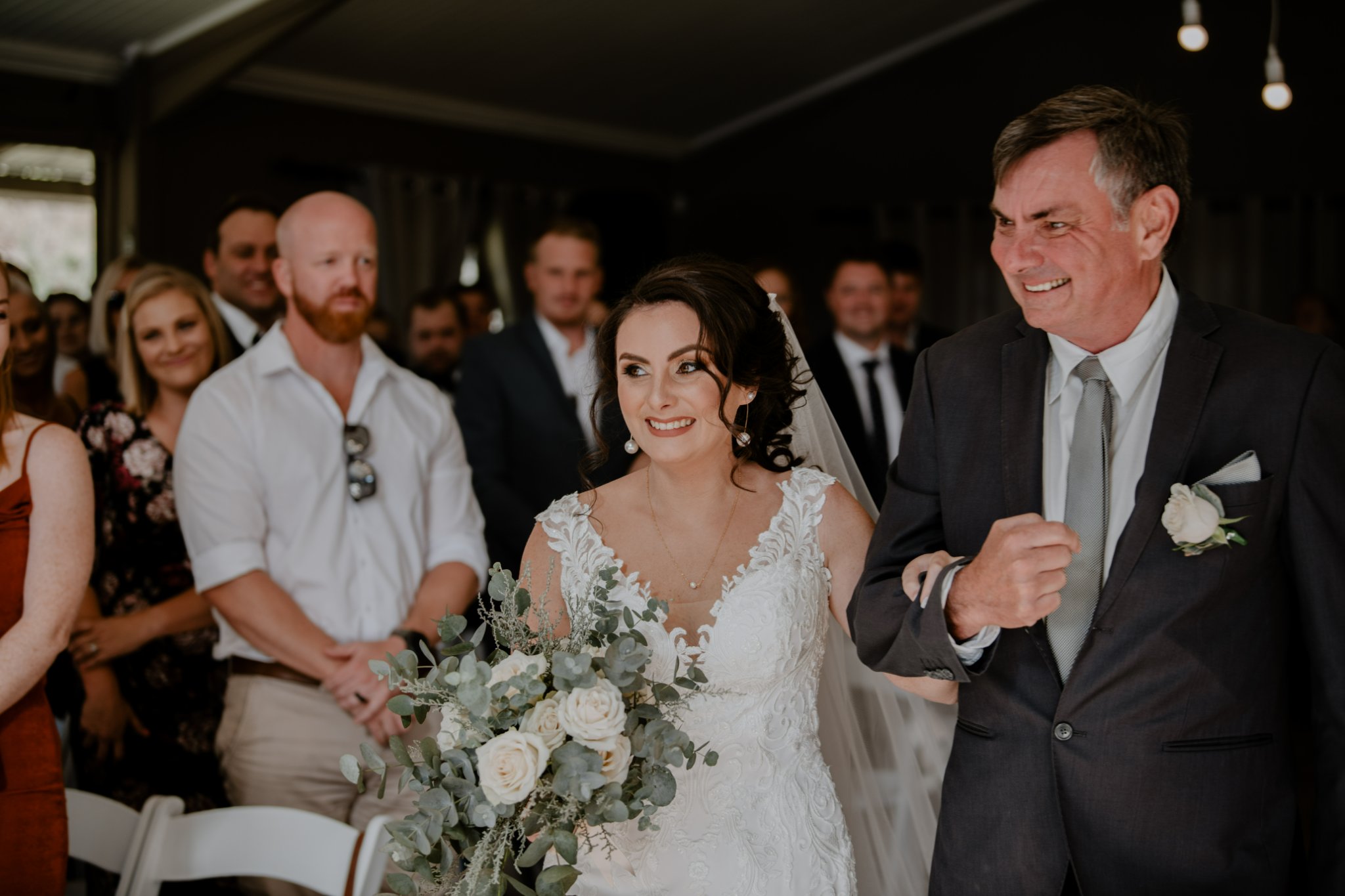 happy father and daughter walk down isle 