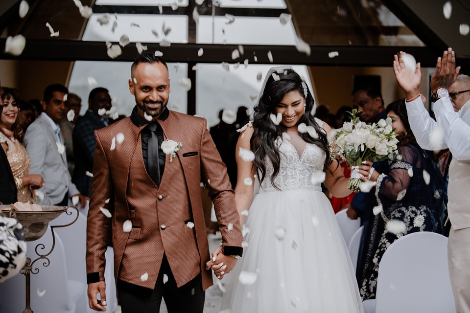  man and wife walking through confetti 