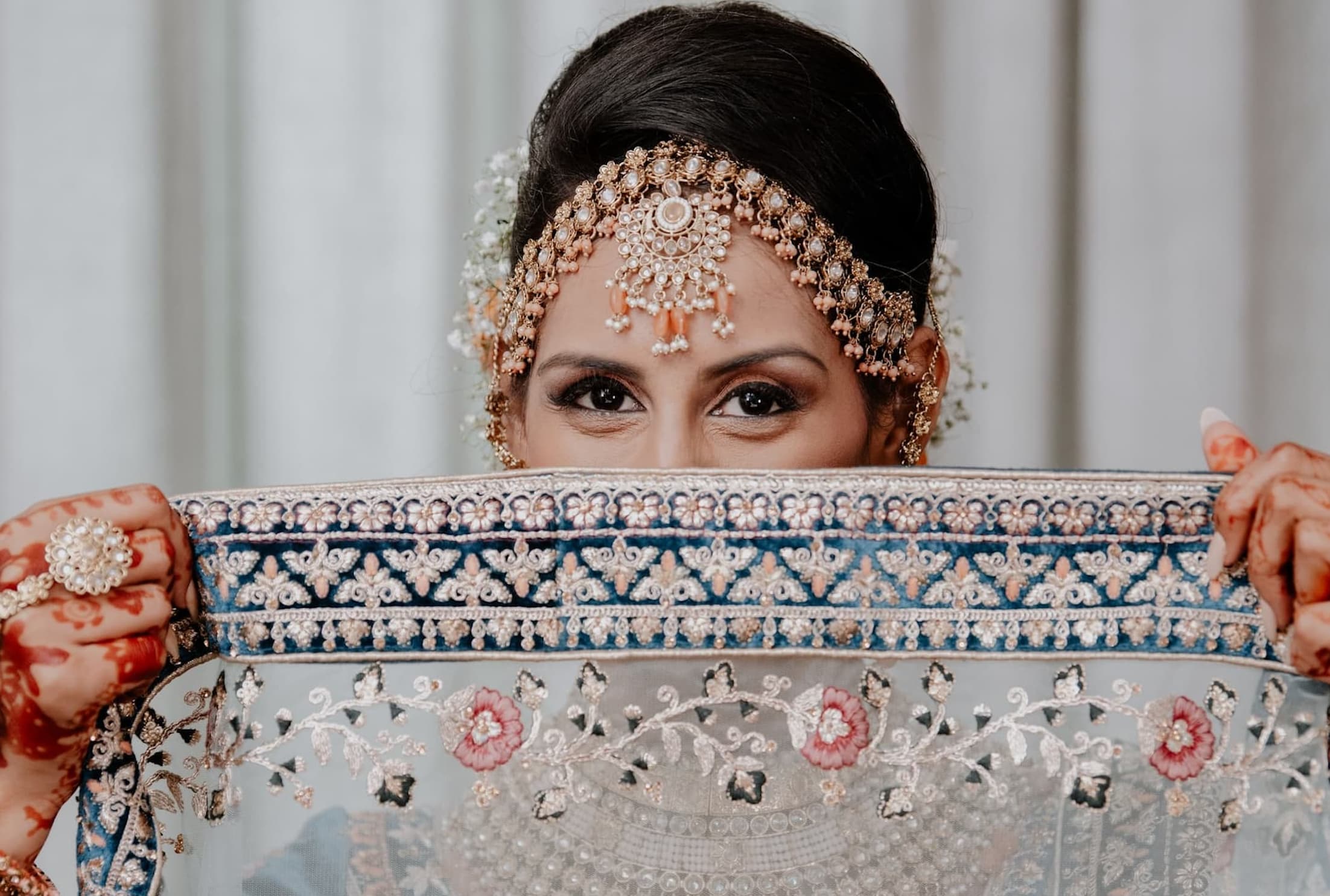  woman peaking over traditional cloth 